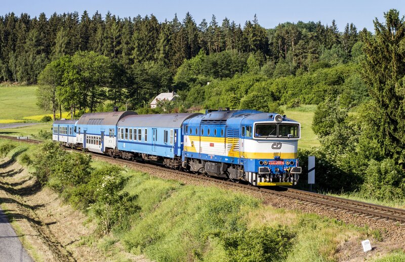 Blue Train on Tracks — Serene, Afternoon