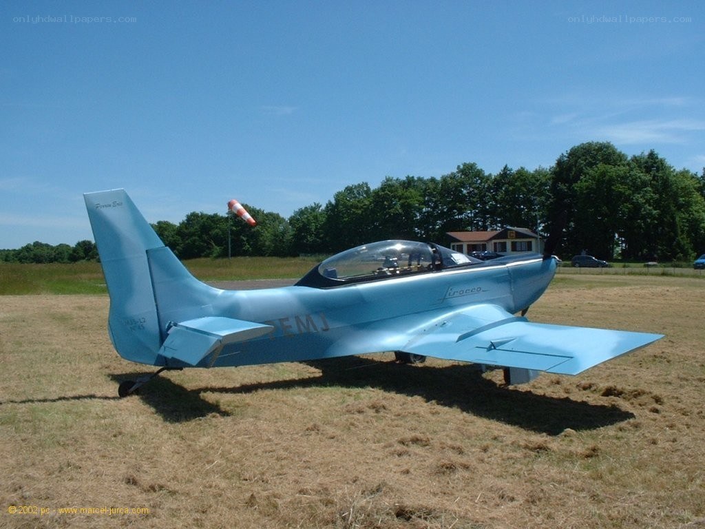 blue training aircraft on field