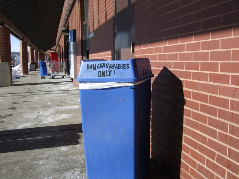 Blue trash can with sign