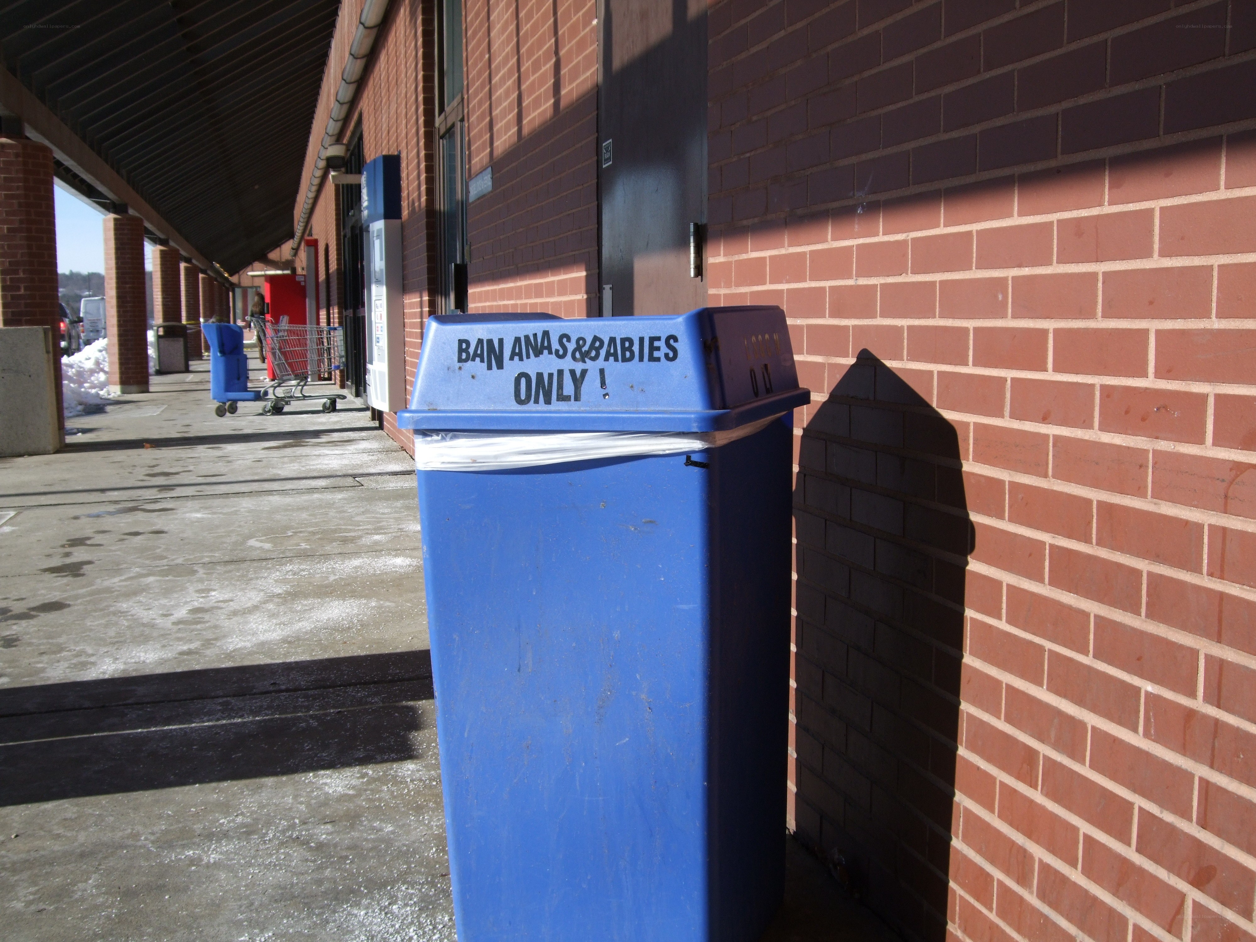 Blue trash can with sign