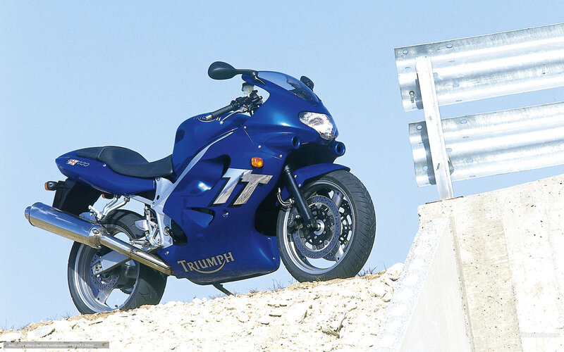 Blue Triumph motorcycle on hill