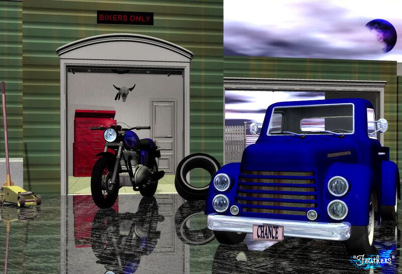 Blue truck and motorcycle in garage