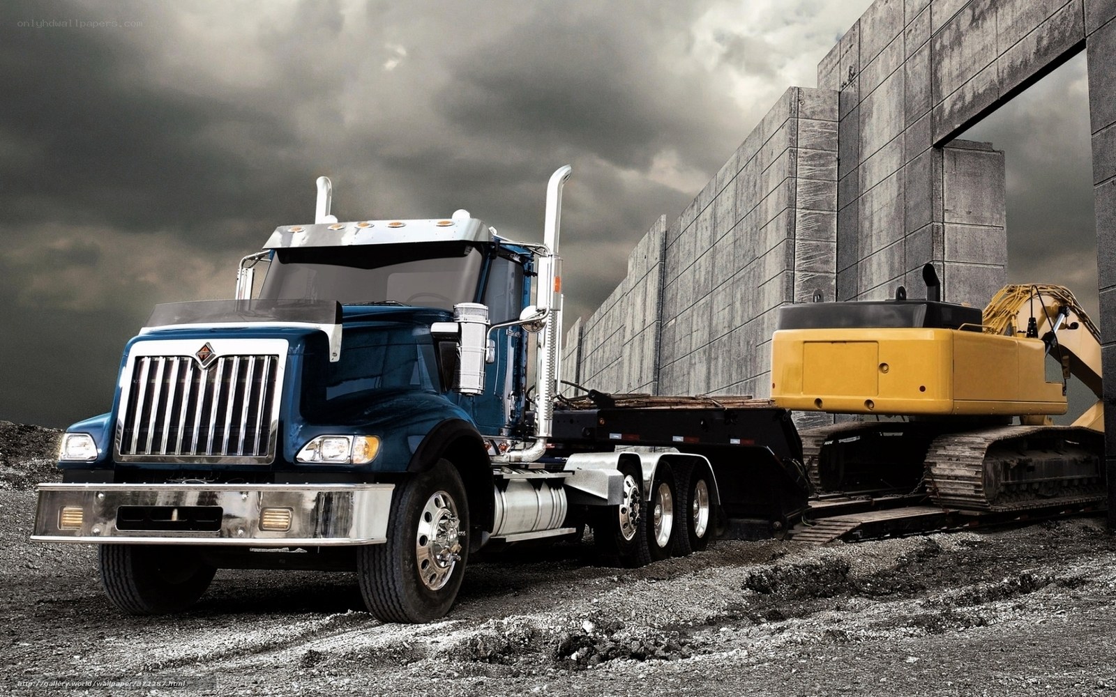Blue truck hauling excavator