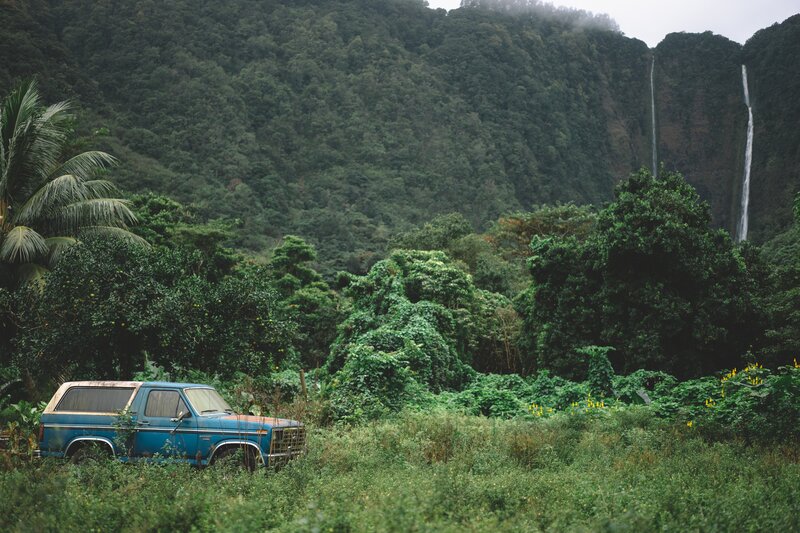 Blue truck near waterfall