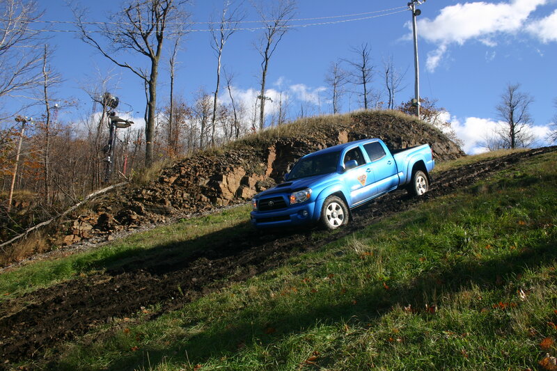 Blue truck on muddy hill