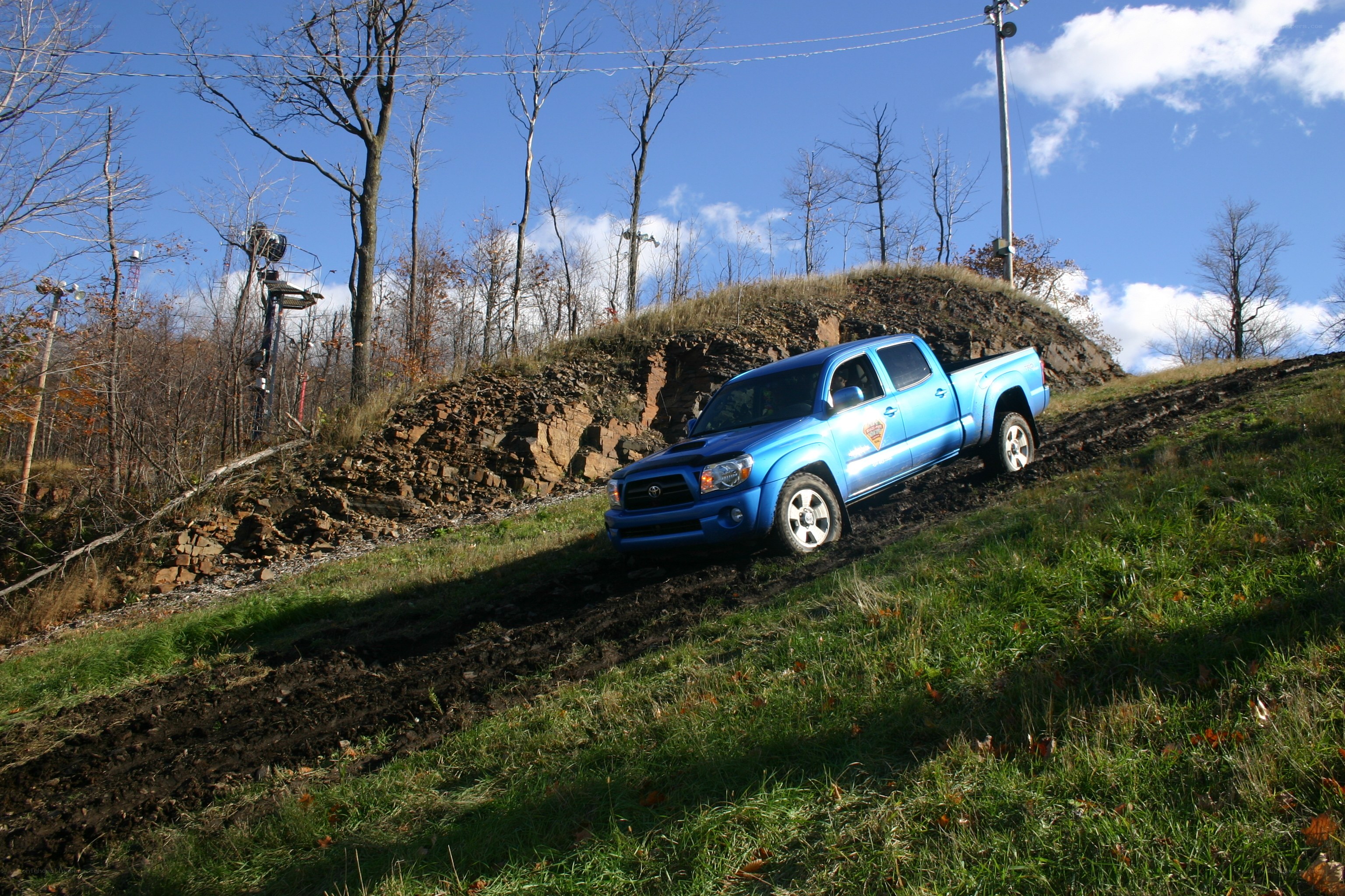Blue truck on muddy hill