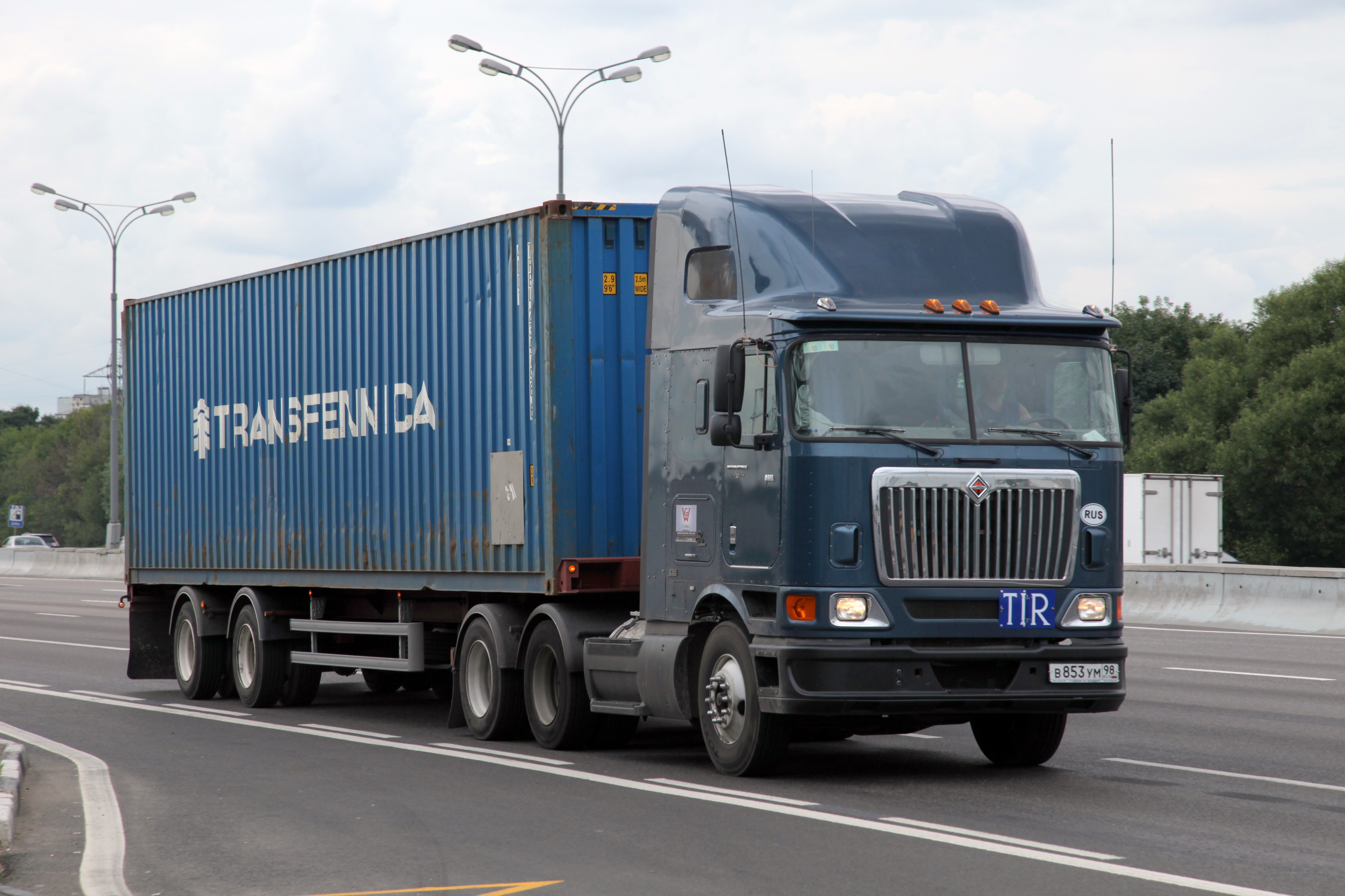 Blue truck with container on highway