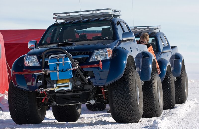 Blue trucks in snowy landscape