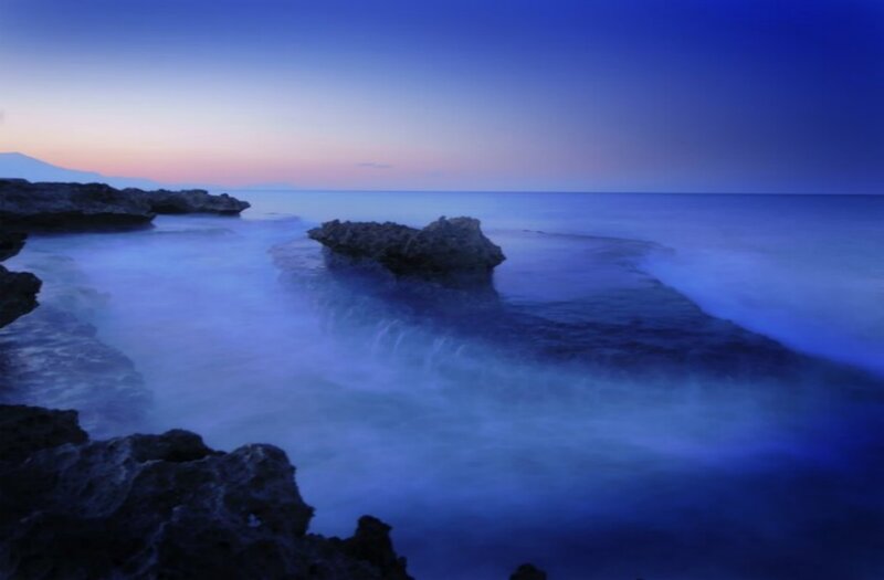 Blue twilight at rocky coastline