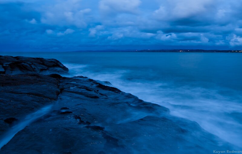 Blue twilight at the rocky shore