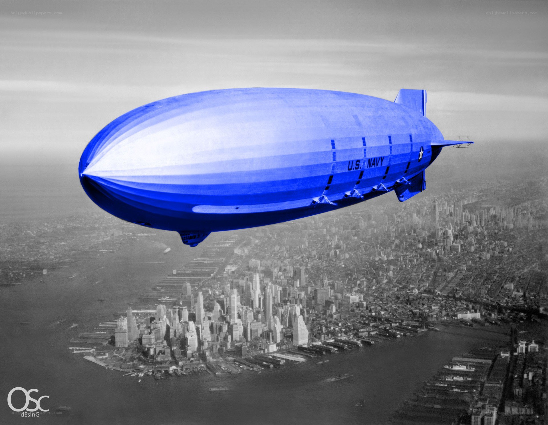 Blue U.S. Navy blimp over city