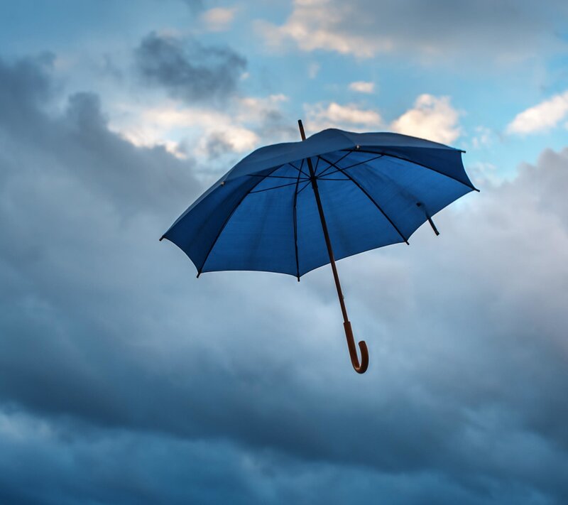 Blue Umbrella in Sky — Dramatic