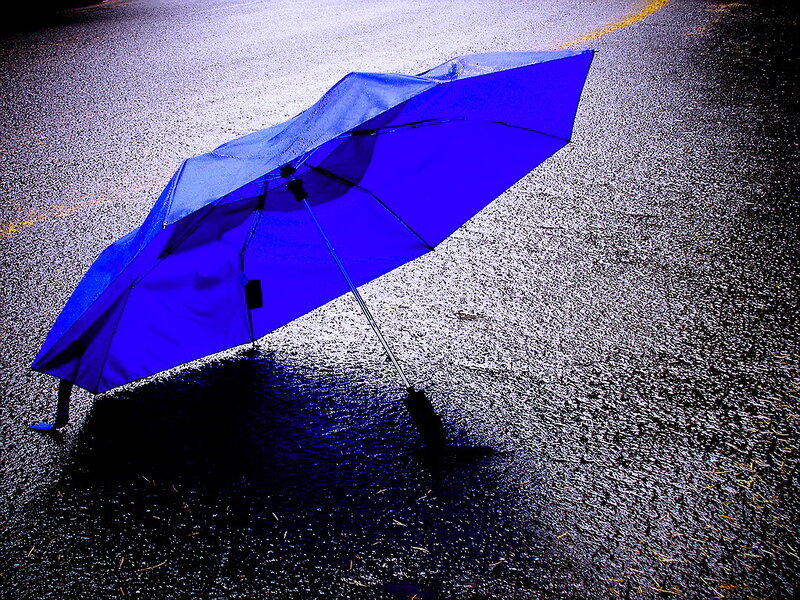 Blue Umbrella on Pavement