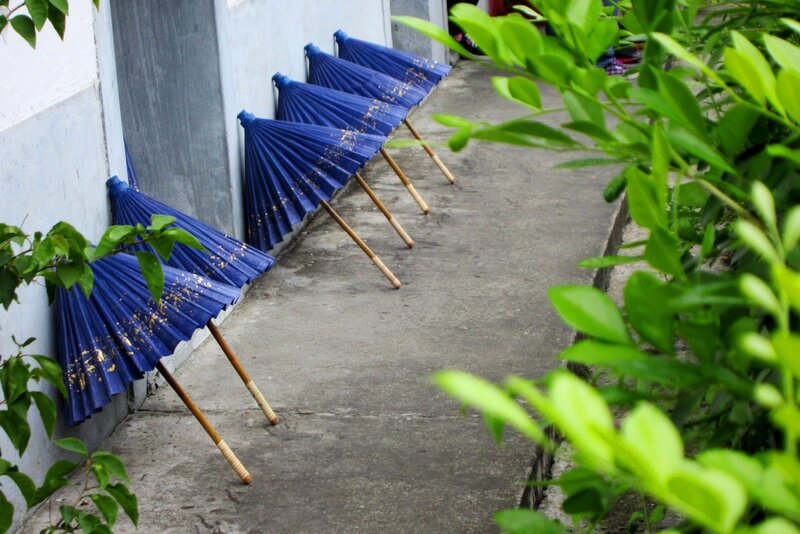 Blue Umbrellas Leaning