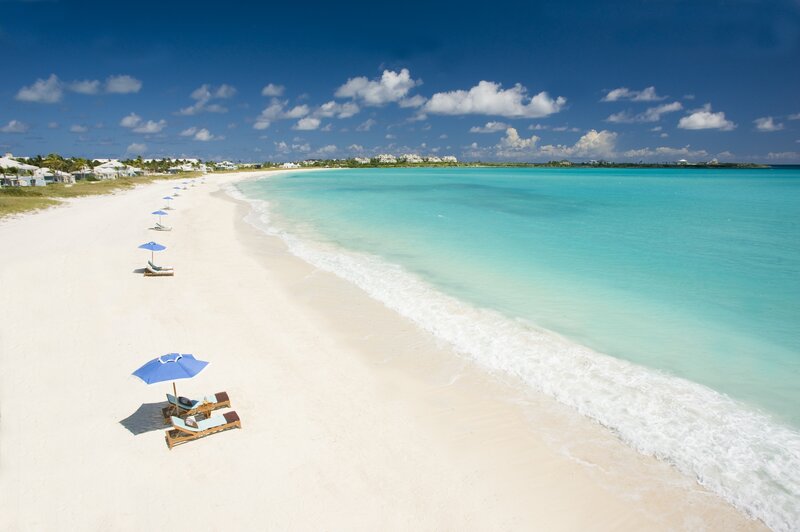 Blue Umbrellas on Beach — White, Serene, Afternoon