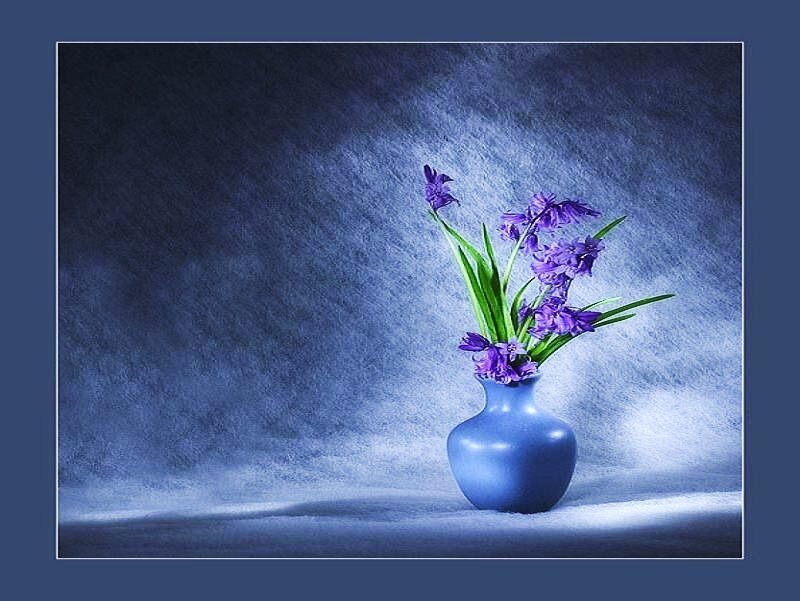 Blue vase with purple flowers