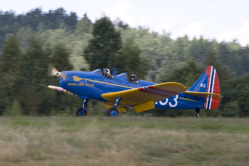 Blue vintage airplane in flight