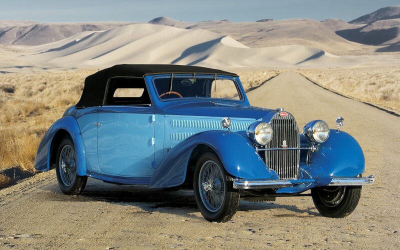 Blue vintage Bugatti on desert road