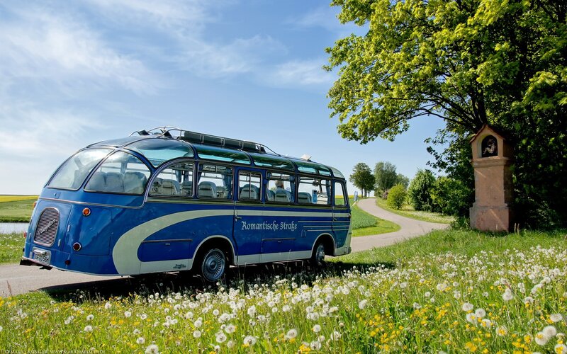 Blue vintage bus on a country road