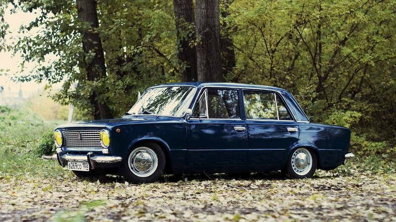 Blue vintage car in autumn forest
