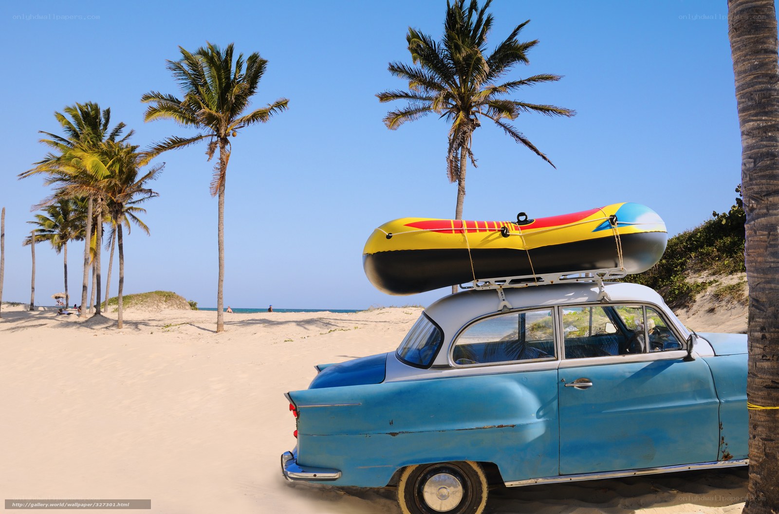 Blue vintage car on tropical beach