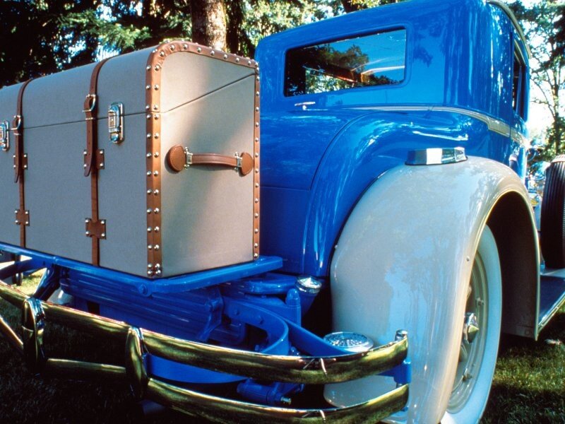 Blue vintage car with luggage trunk