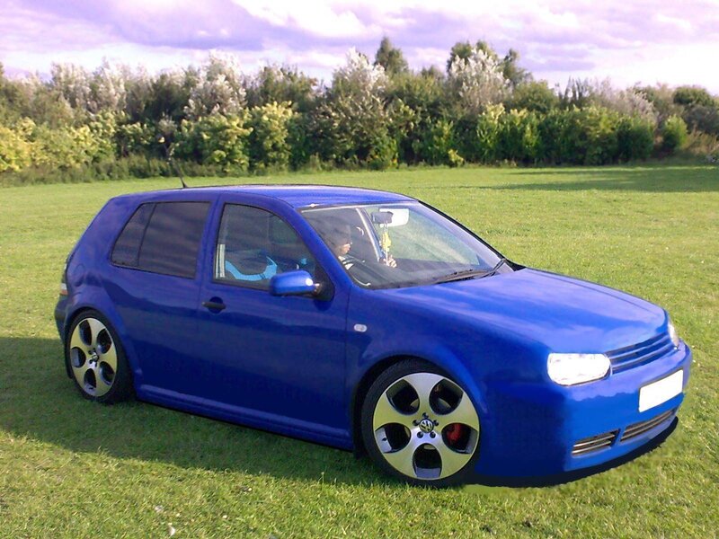 Blue Volkswagen Golf in a field