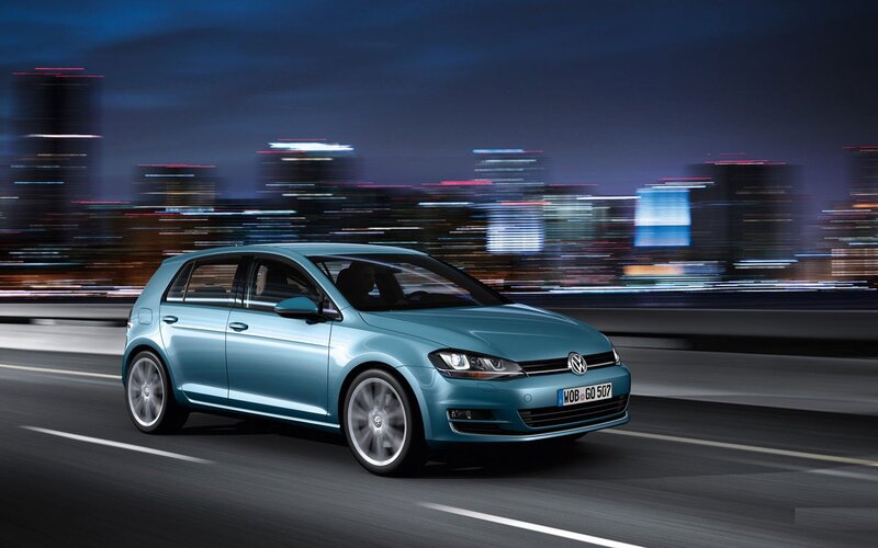 Blue Volkswagen Golf on city road