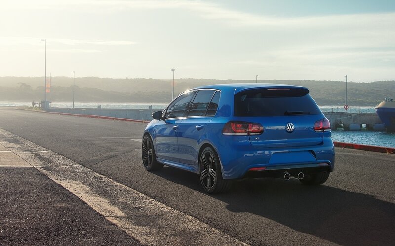 Blue Volkswagen Golf R parked at harbor