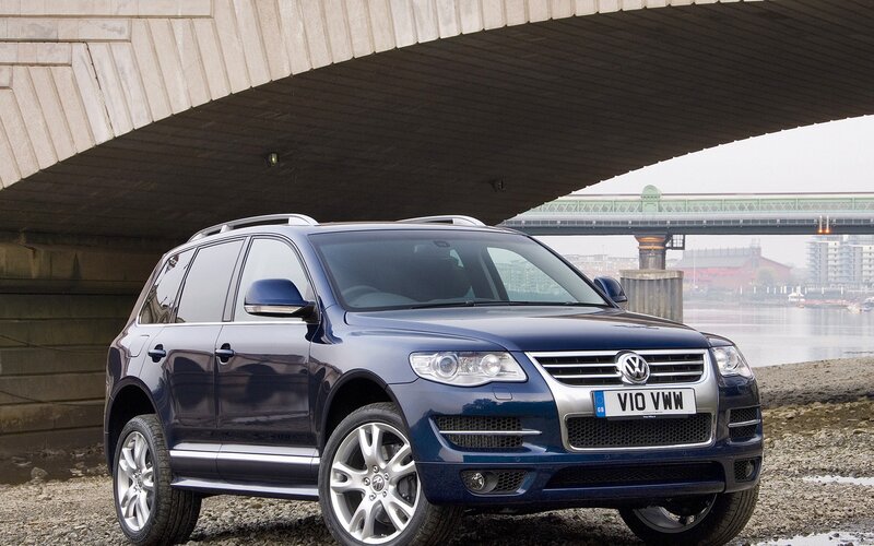 Blue Volkswagen Touareg under bridge