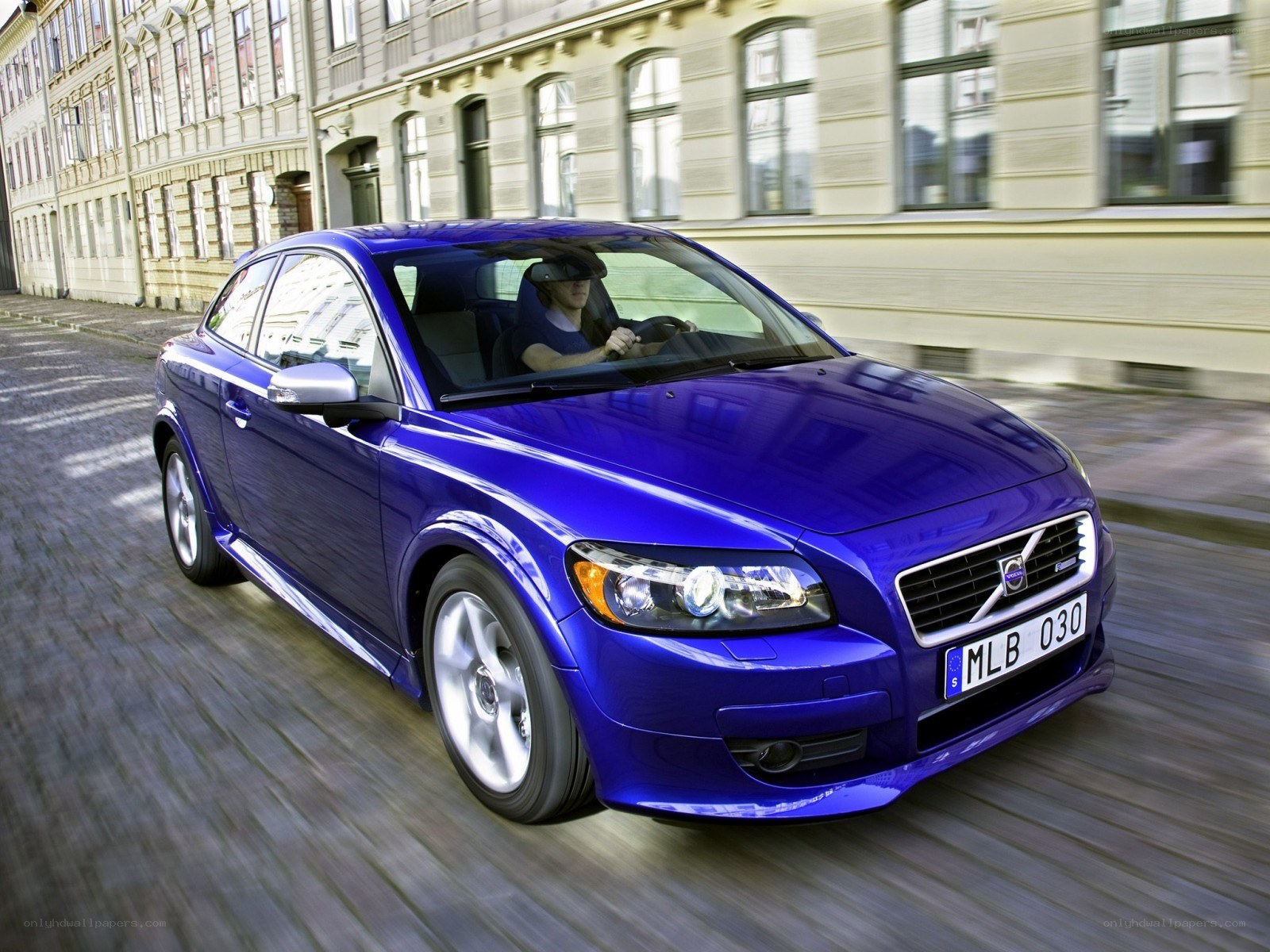 blue volvo c30 in motion