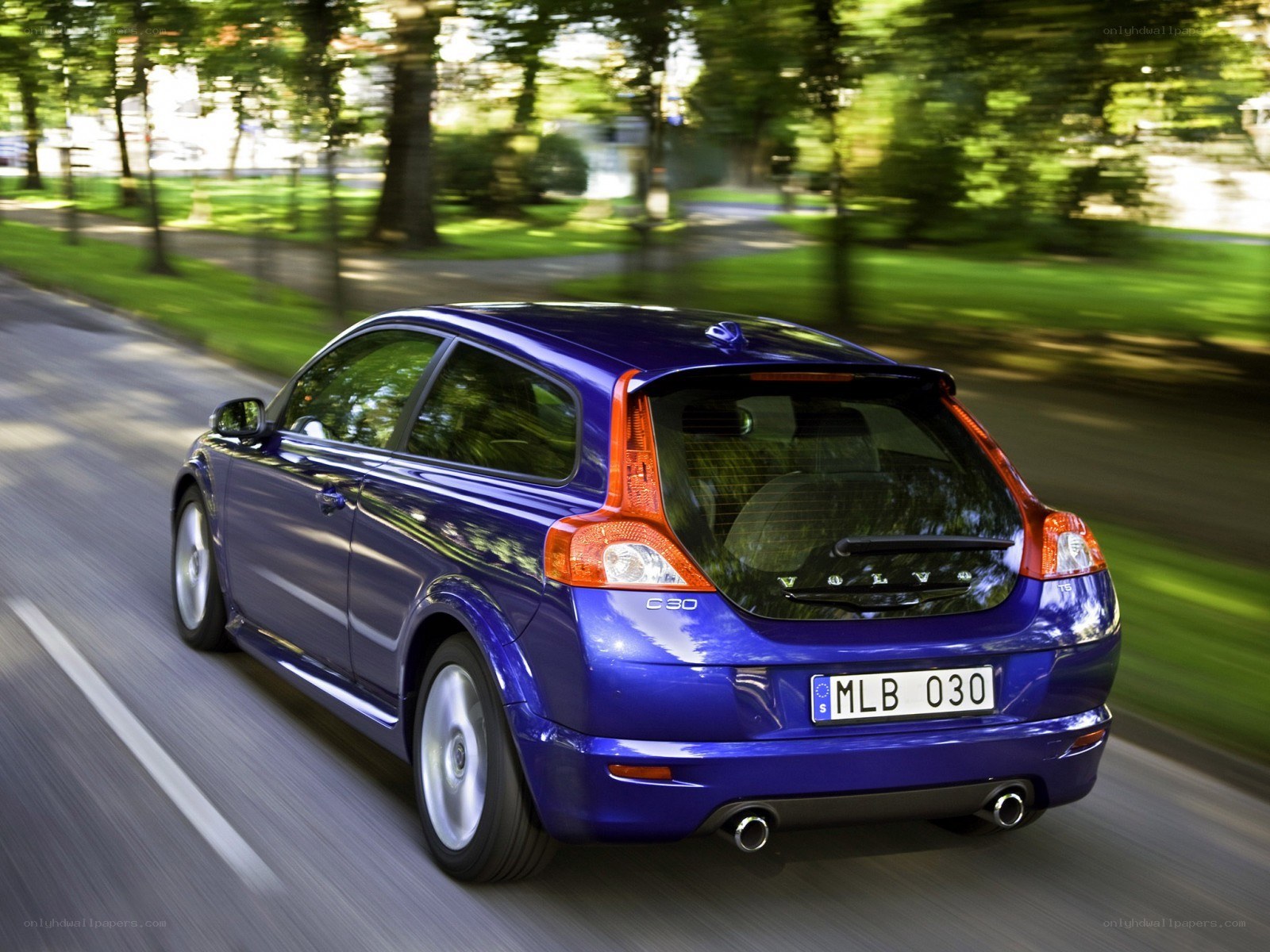 blue volvo c30 in motion