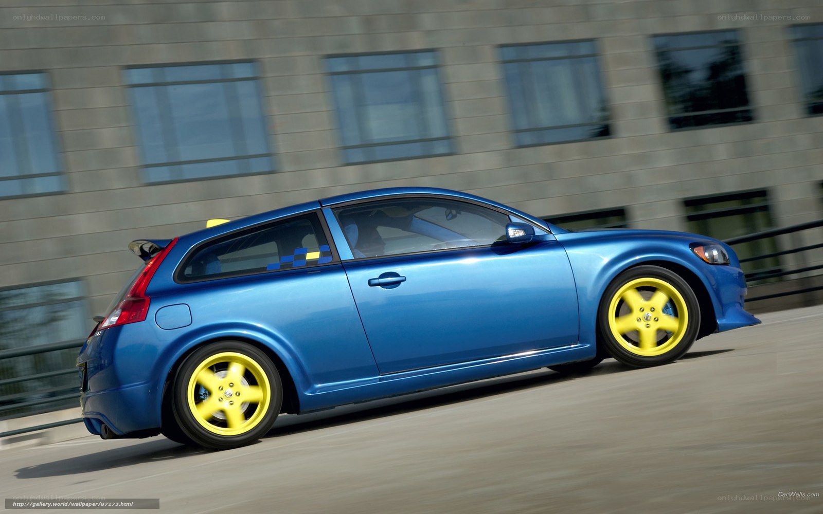 blue volvo c30 in motion