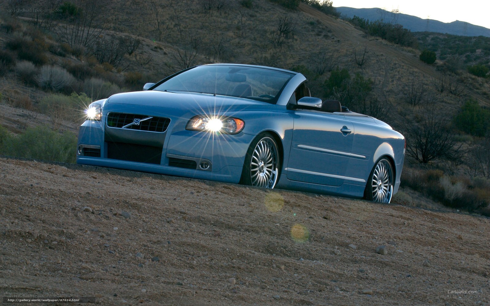 blue volvo convertible on hillside