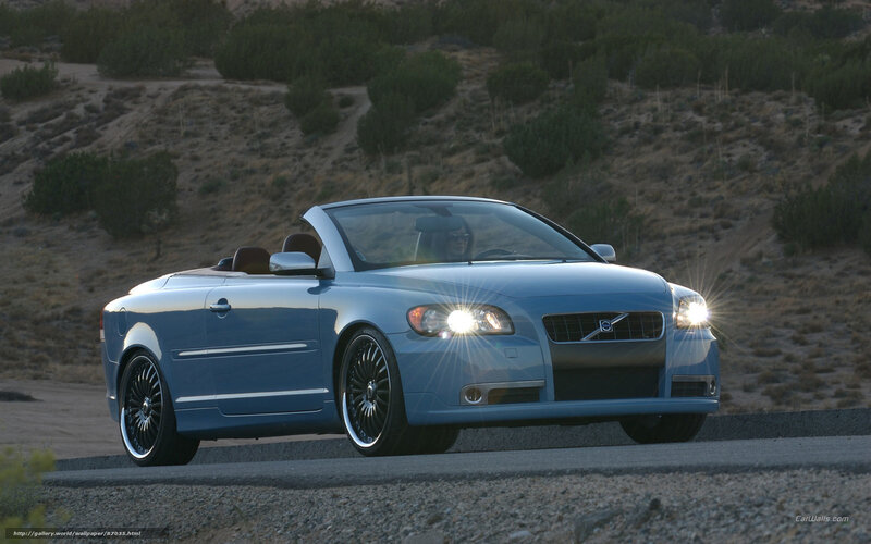 blue volvo convertible on road