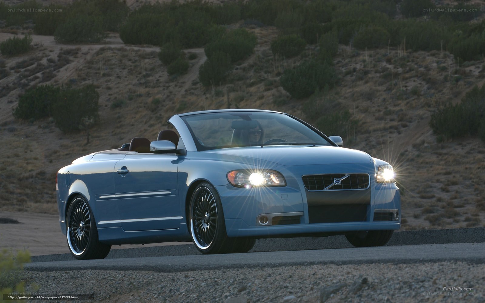 blue volvo convertible on road