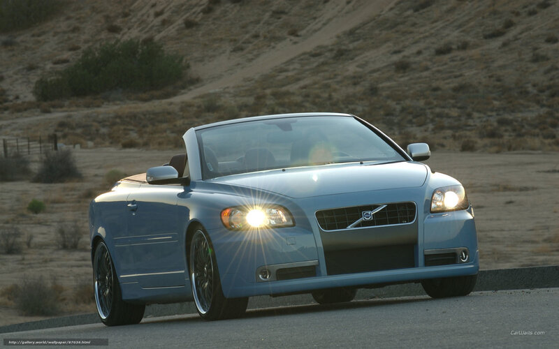 blue volvo convertible on road