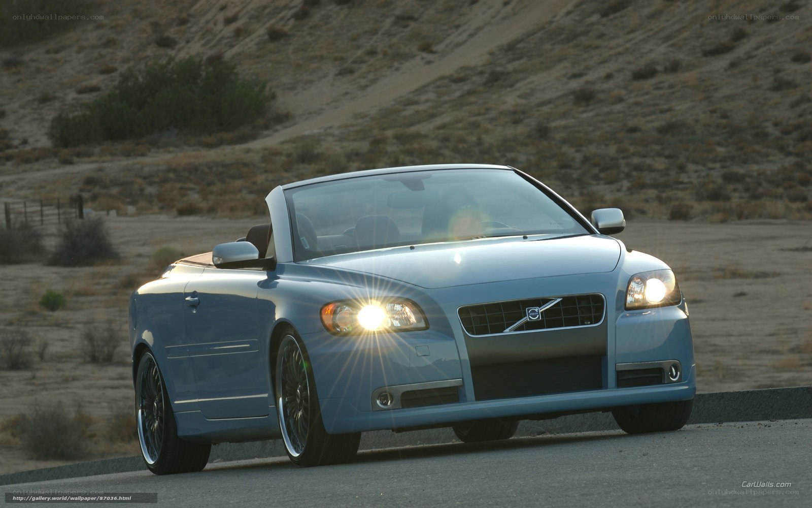blue volvo convertible on road