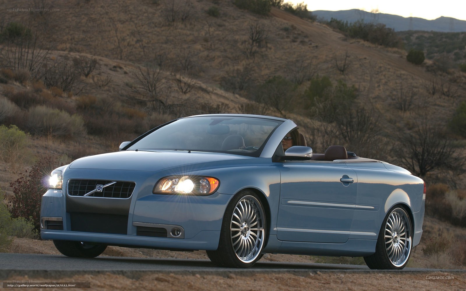blue volvo convertible on road