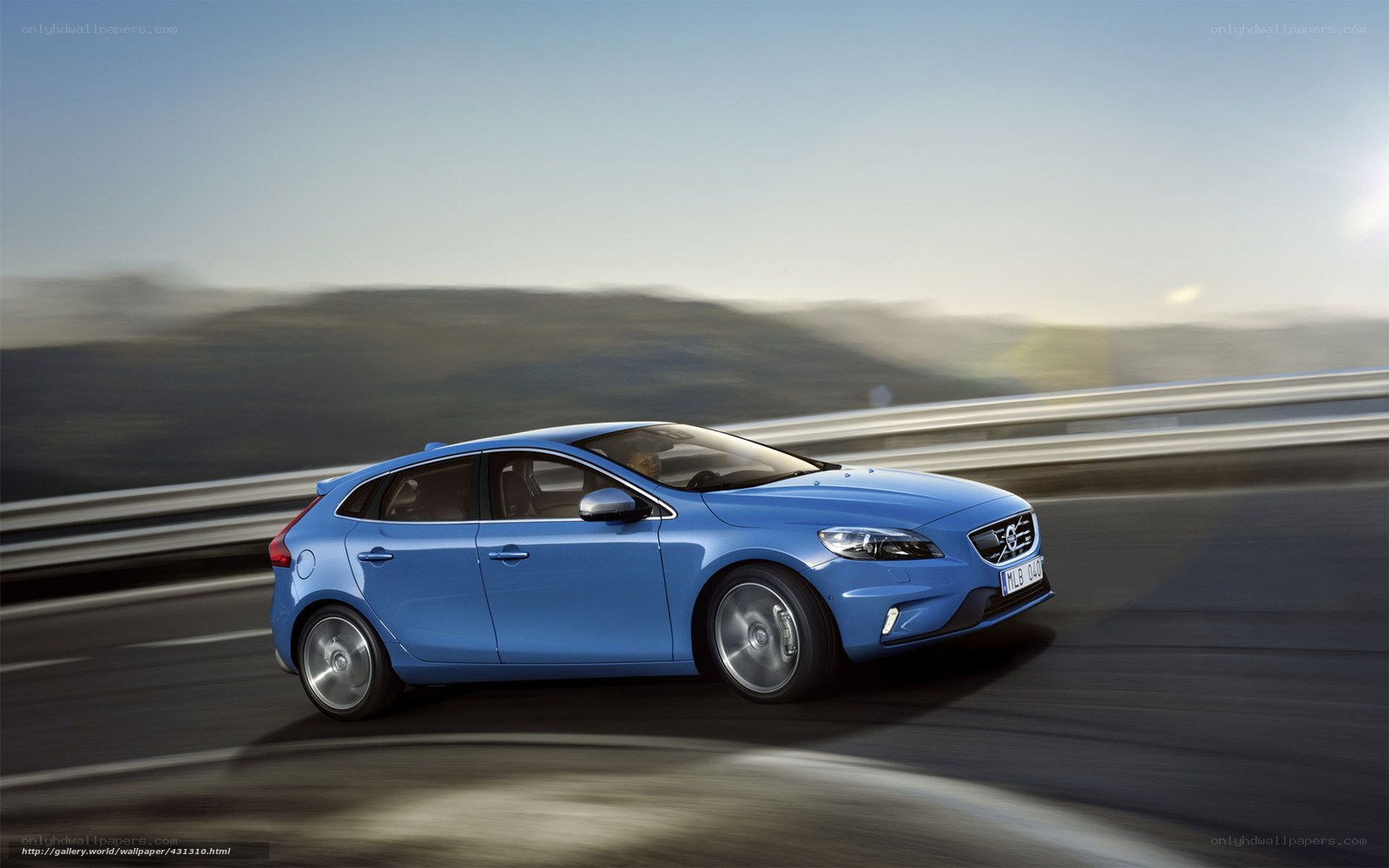 blue volvo driving on highway