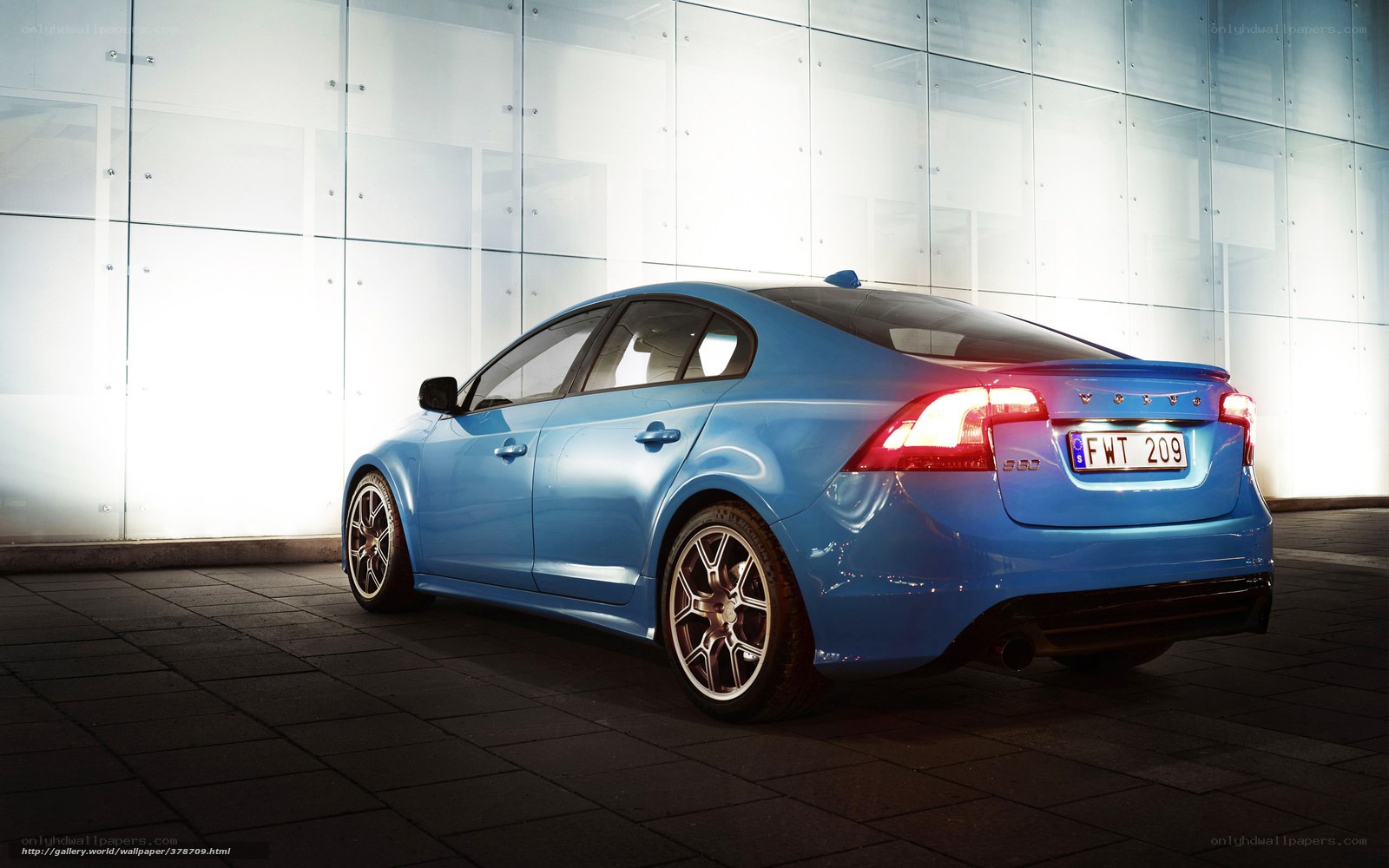 Blue Volvo S60 in modern setting