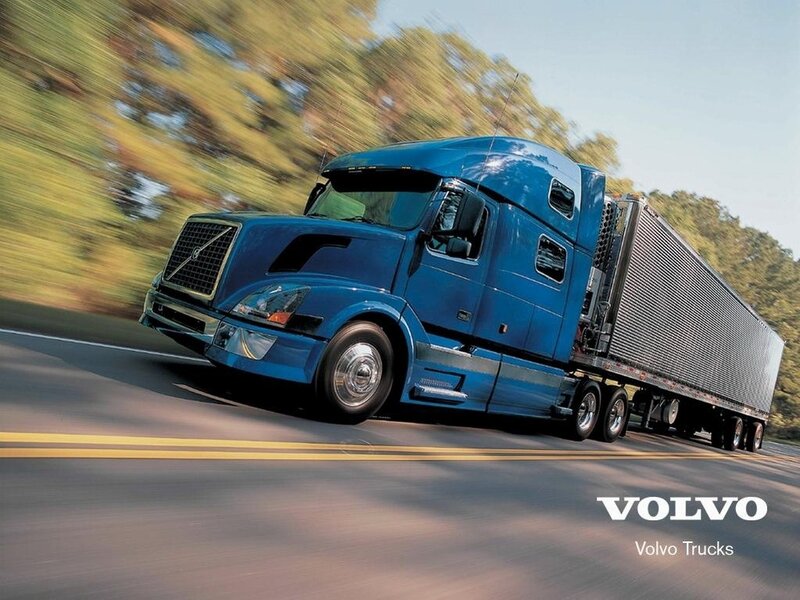 Blue Volvo semi-truck in motion