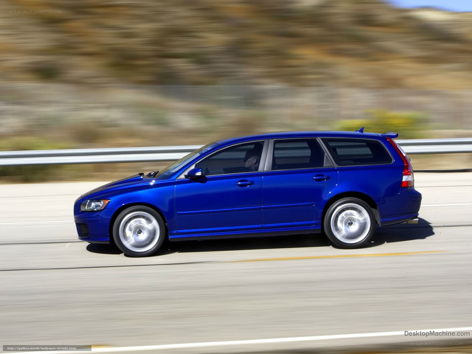 blue volvo station wagon in motion