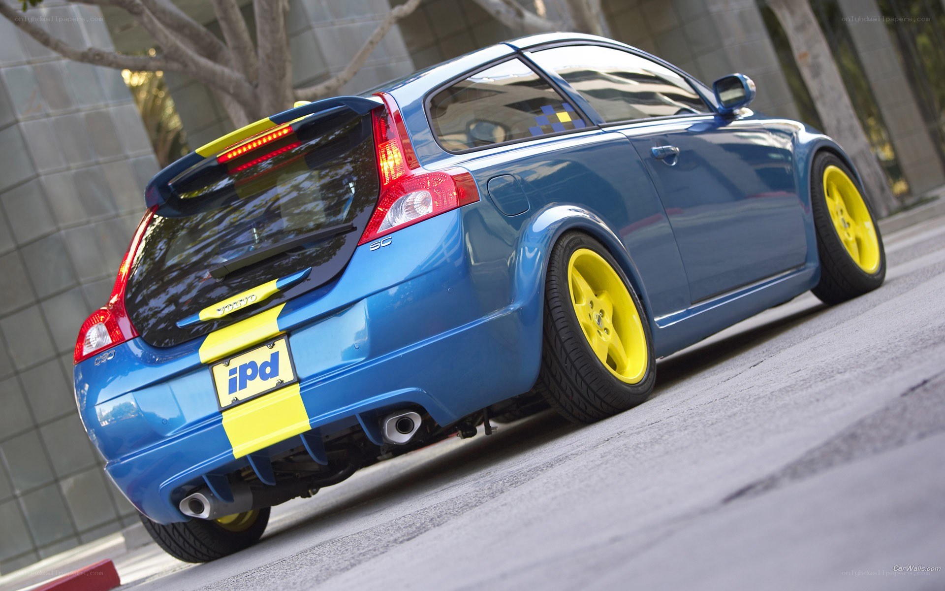 blue volvo with yellow wheels