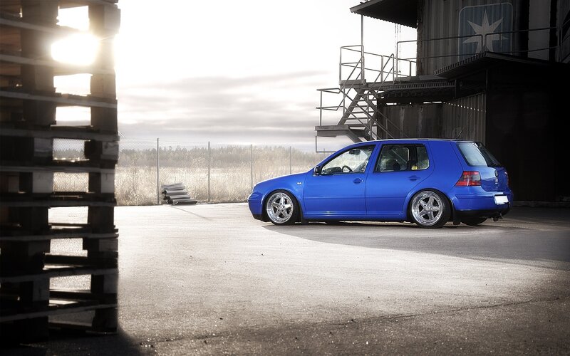 Blue VW Golf in industrial setting