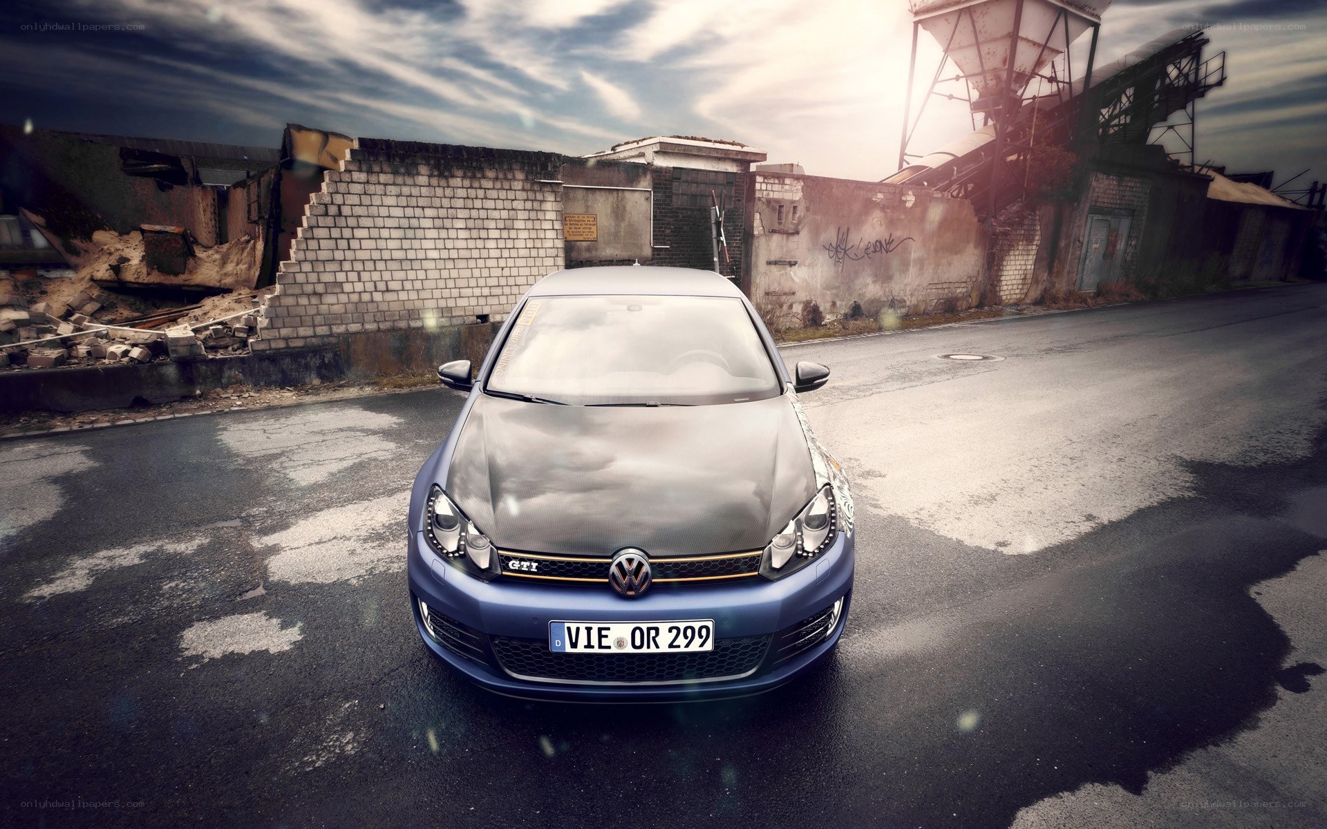 Blue VW GTI in industrial setting