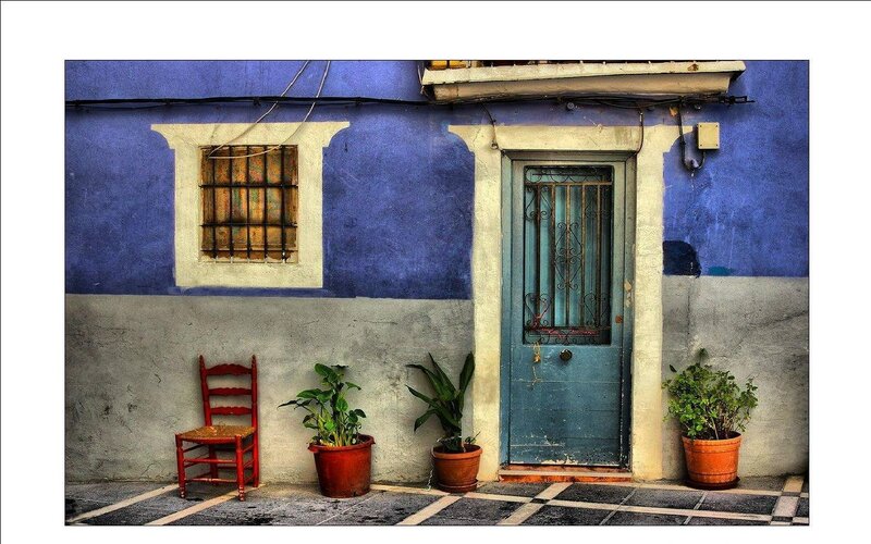 Blue-walled house with red chair