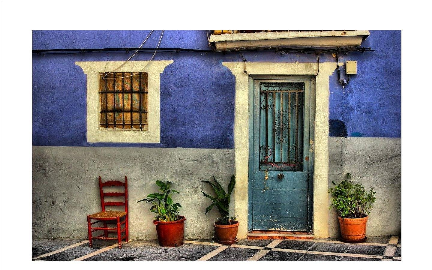 Blue-walled house with red chair