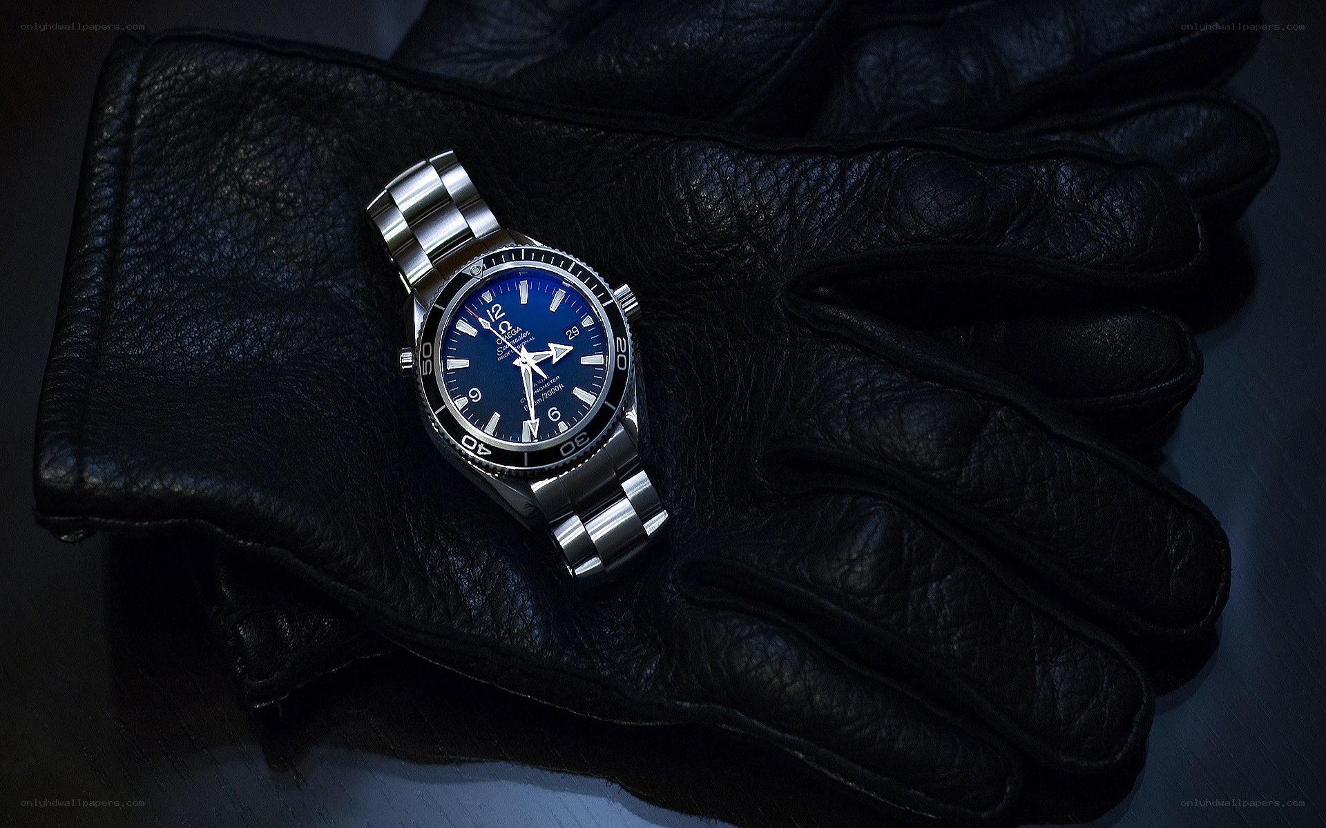 Blue watch on black glove
