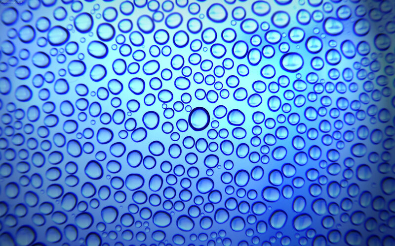 Blue water droplets on glass